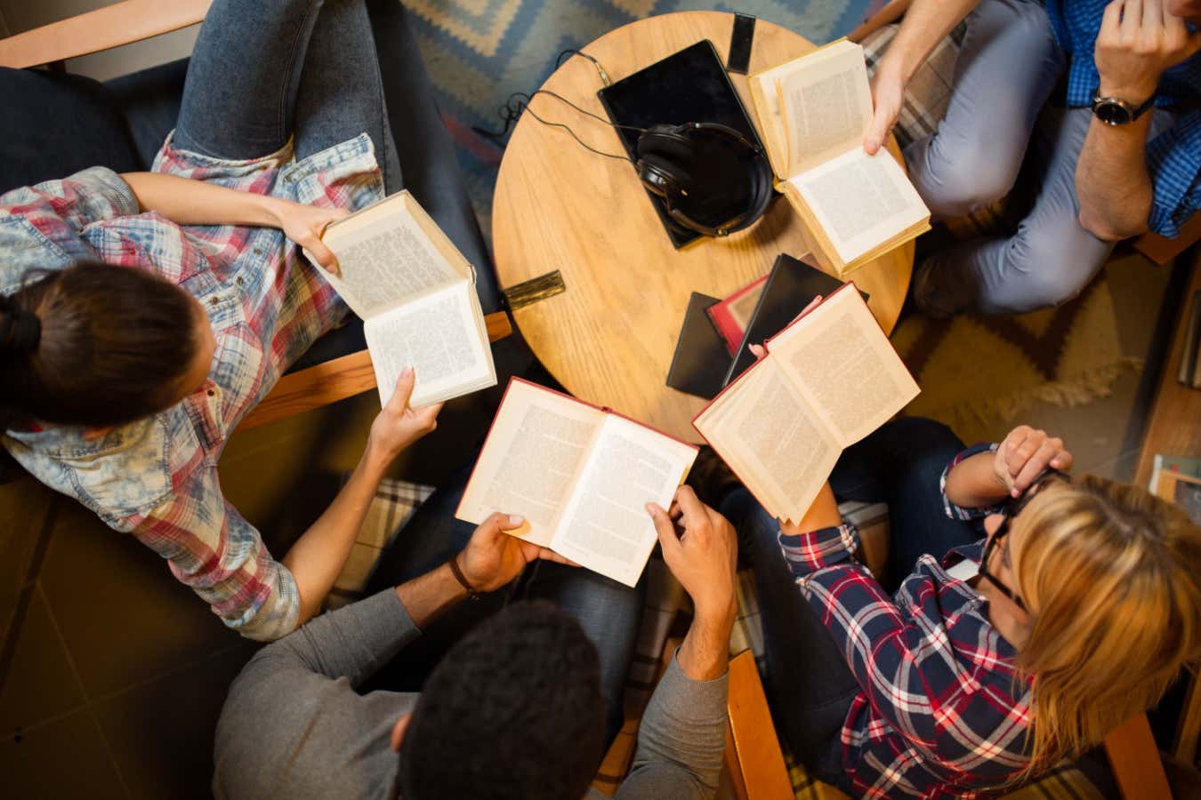 Diverse group of friends discussing a book in library