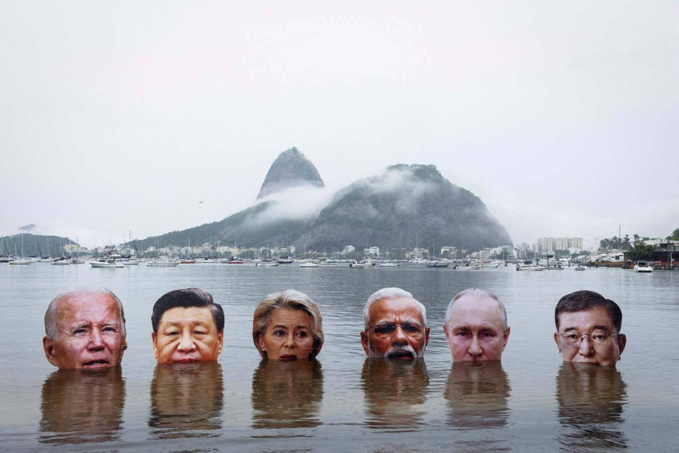 Members of the Indigenous People Association stage a protest to demand action on climate change, holding big head cut-outs of world leaders U.S. President Joe Biden, China's President Xi Jinping, European Commission President Ursula von der Leyen, India's Prime Minister Narendra Modi, Russian President Vladimir Putin and Japan's Prime Minister Shigeru Ishiba, on the waters of Botafogo Bay, ahead of the G20 Summit, in Rio de Janeiro, Brazil November 16, 2024. REUTERS/Tuane Fernandes SEARCH 