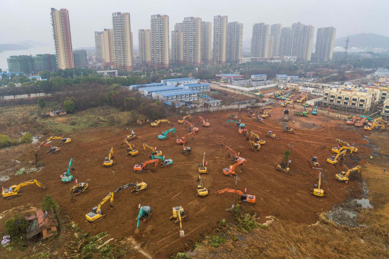 An aerial photo taken in January 2020 shows excavators at the construction site of a new hospital being built to treat people with covid-19 in Wuhan, China