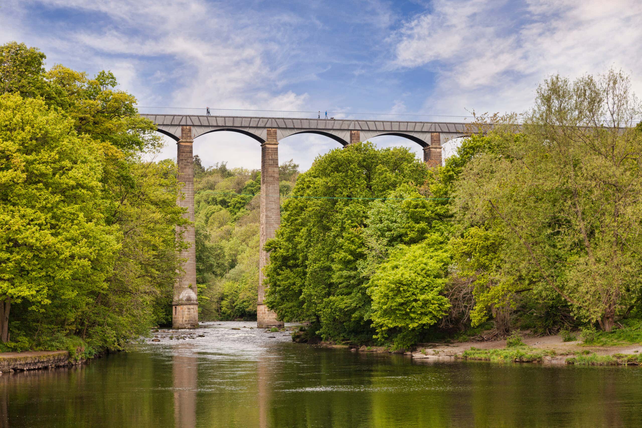 Pontcysyllte Aqueduct, built by Thomas Telford, and a World Heritage Site, reflecting in the River Dee, with people walking across, near Llangollen, County Borough of Wrexham, Wales, UK